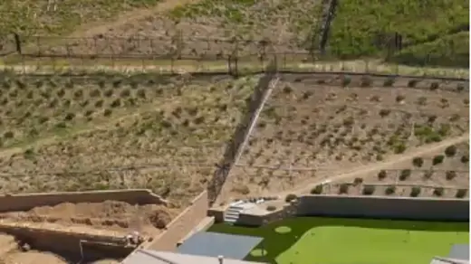 aerial view of a modern, single-story home with a clean and well-maintained exterior